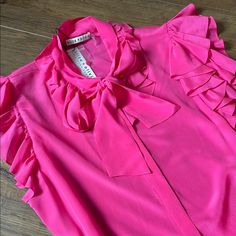 Gorgeous (Nwt) Alice + Olivia Fuchsia Short Sleeve, Bow, Ruffled Sleeve Blouse! Lightweight, Button Down, Made Of 100% Silk. Size Xl Bust (Laying Flat/Pit To Pit)-19 Inches Length (Laying Flat)-25 Inches Retails For $285 Bundle & Save $$ Price Is Firm Not Accepting Offers Thank You For Looking! No Trades Please. Packages Ship Daily Mon.-Fri., Sometimes On Saturdays. Please Be Patient As My Post Office Is Sometimes Slow Pink Tie Neck Top For Work, Pink Tie Neck Top For Party, Formal Pink Blouse With Ruffles, Pink Fitted Tie Neck Top, Pink Ruffled Tops For Formal Occasions, Formal Pink Ruffled Top, Pleated Sleeves Blouse, Olivia Pink, Black Silk Blouse