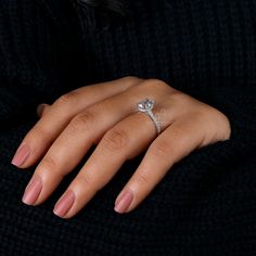 a woman's hand with a diamond ring on it