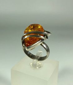 Discover the timeless elegance of our Spectacular Orange Amber Ring, expertly crafted for ladies in stunning 925 melting silver. This exquisite piece features natural Baltic Sea amber, renowned for its unique beauty and healing properties. Perfect for any occasion, this amber ring will add a touch of sophistication to your jewelry collection. Product Details: Material: 925 Sterling Silver Stone: Natural Baltic Sea Amber Color: Spectacular Orange Design: Melting Silver Style Ring Size: 8 Us size Unique Formal Rings With Polished Finish, Modernist Stamped 925 Jewelry For Formal Occasions, Modernist Formal Jewelry Stamped 925, Formal Sterling Silver Rings With Shiny Finish, Sterling Silver Ring With Shiny Finish, Sterling Silver Rings With Shiny Finish For Formal Occasions, Unique Formal Sterling Silver Rings, Formal Sterling Silver Rings With Polished Finish, Unique Sterling Silver Rings For Formal Occasions