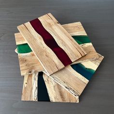 four pieces of wood are stacked on top of each other, with different colors in them