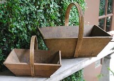 two wooden baskets sitting on top of a table