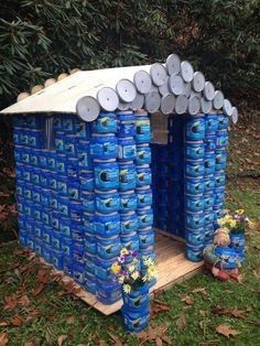 a blue house made out of plastic water bottles