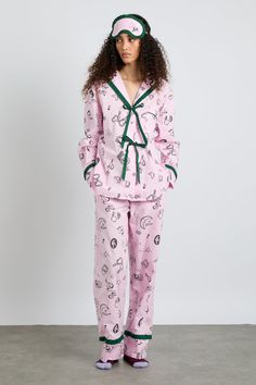 Pink and pretty, our Antonella pyjama set features hand-illustrated print design and a button-down front with functional bows. • Top and bottoms • Matching bag included • Matching eye mask available • Button-down front • Functional bows • Chest pocket • Elasticated waist with functional tie • 100% organic cotton • Designed in London MODEL INFO: Model is 5'10 and is wearing a UK 8. Damson Madder, London Models, Cotton Pjs, Fashion Designing, Checked Scarf, Hooded Scarf, Striped Scarves, Pink Gingham, Striped Cardigan