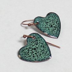 "Green on green crackle enamel hearts - minty grass green beauties.  .5\" by .5\". SOLID TITANIUM EARWIRES ARE AVAILABLE FREE UPON REQUEST - please message me. My enameled items are made with love using glass powder enamels on copper, kiln-fired to about 1500oF, and require many layers and firings. Backs are finished with enamel, and pieces are set with copper findings. I have been in the glassworking and jewelry-making trades since 1994 and have a deep love and respect for glass of any kind." Hypoallergenic Green Enamel Jewelry, Green Teardrop Enamel Jewelry, Handmade Green Heart Earrings As Gift, Handmade Green Heart Earrings For Gift, Green Enamel Jewelry With Black Enamel, Small Handmade Green Jewelry, Handmade Small Green Jewelry, Green Nickel-free Heart Earrings As Gift, Green Heart-shaped Earrings For Gifts