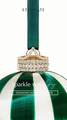 a green and white striped ornament with two rings on it's side