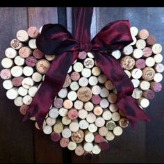 a wreath made out of wine corks with a bow