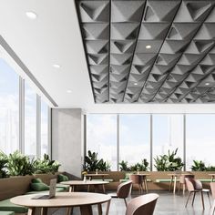 an empty restaurant with tables and chairs in front of large windows