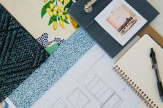 an assortment of papers, notebooks and pens on top of each other with designs