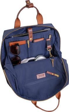 The 18” Metro 1680 Denier Nylon Backpack offers a perfect blend of strength and sophistication. It features a secure snap laptop sleeve (fits most laptops up to 15"), interior slip pockets, and a zippered compartment with a key hook for organized storage. The veg-tanned leather snap top handles and trim add a touch of elegance, while the front zippered compartment and padded back wall enhance practicality and comfort. The adjustable padded back straps with a burnished logo and the add-a-bag feat Organized Storage, Key Hook, Dopp Kit, Key Hooks, Travel Backpack, Back Strap, Duffel Bag, Laptop Sleeve, Laptop Sleeves