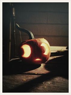 an orange pumpkin with two lights on it