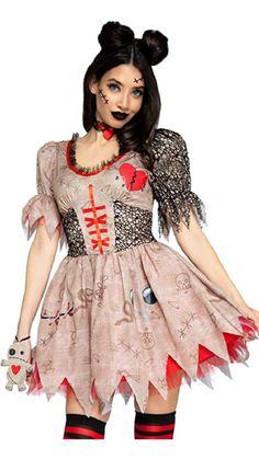 a woman dressed as a zombie holding a teddy bear