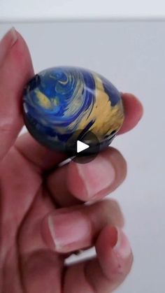 a person holding a marble in their hand