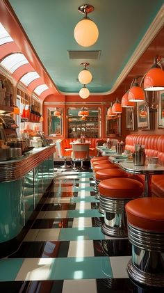 the interior of a diner with checkered flooring and orange booths, lights, and chandeliers