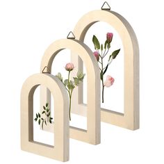 three wooden archs with flowers on them and one has a flower in the middle