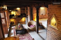 a living room filled with furniture next to a brick wall