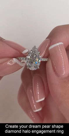 a woman's hand holding a diamond ring with the words create your dream pear shape diamond halo engagement ring