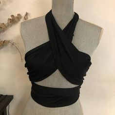 Can Be Worn As A Bikini Top Or A Regular Top With Jeans Or Shorts Wrap Any Way You Like. Doesn’t Have A Size But I Would Assume It’s About A Medium But Prob Can Fit Small Or Large As Well. Never Worn But Doesn’t Have Tag Summer Crisscross Halter Top For Night Out, Triangle Halter Top For Party, Stretch Crisscross Crop Top For Night Out, Black Triangle Crop Top For Night Out, Black Wrap Top For Night Out In Spring, Party Fitted Swimwear With Crisscross Straps, Stretch Crisscross Halter Top For Night Out, Fitted Crisscross Top For Party, Black Strappy Halter Top For Summer