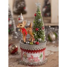 a small christmas tree with a mouse figurine