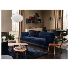 a living room scene with focus on the couch and coffee table in the foreground