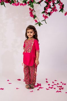 The kurta is beautifully crafted with intricate embroidery or printed motifs on the front panel. It features a straight-cut silhouette that offers a modern yet traditional vibe, ideal for festive occasions or casual wear. The neckline is a classic round  often adorned with delicate lace or piping detailing. The sleeves can be either three-quarter giving it a refined look. The matching printed trousers complement the kurta with their vibrant, playful patterns. The trouser fit is tailored but comf Cotton Sets With Mirror Work For Eid, Festive Pant Set With Mirror Work And Straight Kurta, Festive Sets With Zari Work On Straight Kurta, Festive Straight Kurta Pant Set With Mirror Work, Festive Straight Kurta Sets With Embroidered Border, Festive Straight Kurta Dress With Embroidered Border, Festive Palazzo Set With Straight Kurta And Mirror Work, Festive Palazzo Set With Mirror Work, Festive Cotton Palazzo Set With Mirror Work