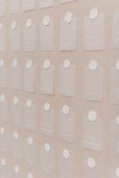 a wall covered in lots of white paper with small circles on the top and bottom