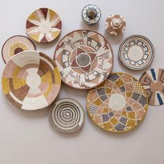 several bowls and plates are arranged on a table top, including one with an abstract design