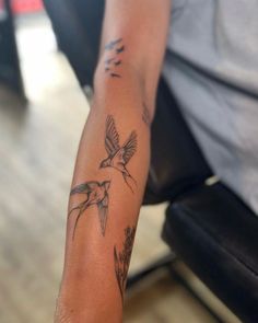 a person with a bird tattoo on their arm