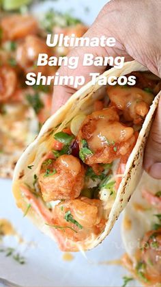 the ultimate bang bang shrimp tacos are ready to be eaten and served on a plate