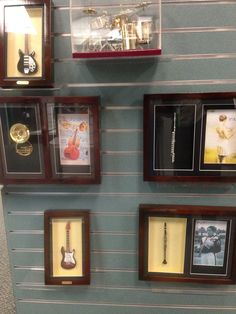 there are many framed guitars on the wall