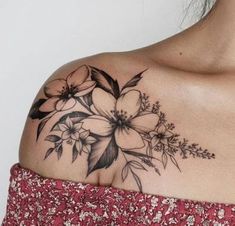 a woman with a flower tattoo on her shoulder