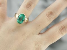 This vintage emerald ring is a simple, and quite a versatile piece with clean lines and great proportions. This ring is classic and traditional, featuring a solid gold head to hold the stone securely. The beautiful emerald has a shade of green that is just the same as the brightest springtime leaves. Metal: 14K Yellow Gold Gem: Emerald 4.08 Carats Gem Measurements: 12.1 x 8.5 mm, Oval Ring Size: 6 Marks: "KIMBERLY 14K" Stamped on the inside band Antique Emerald Ring With Prong Setting, Timeless Yellow Gold Signet Ring With Emerald, Timeless Yellow Gold Emerald Signet Ring, Antique Emerald Cut Yellow Gold Emerald Ring, Antique Style Emerald Cut Emerald Ring With Prong Setting, Antique Emerald Cut Emerald Ring, Classic Emerald Signet Ring With Bezel Setting, Classic Emerald Signet Ring For Wedding, Classic Emerald Ring With Round Band For May Birthstone