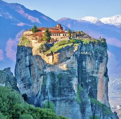 a castle on top of a rock formation in the mountains