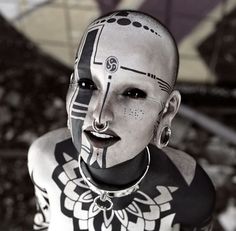 a woman with black and white face paint on her body