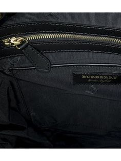 The Burberry Large 'Rucksack' Backpack, crafted with sustainable nylon and leather trims, measures 15.5 x 15.4 x 9.5 inches. Its black color and sophisticated design make it a statement piece. It features a drawstring fastening, top handle, adjustable shoulder straps, padded back, and multiple pockets for storage. Made in Italy, it is finished with beige buckle detailing, gold-toned hardware, and a logo plaque in gold-tone letters. Dimensions: 15.5 x 15.4 x 9.5 inches; Color: Black. Sustainable Designer Black Backpack With Top Carry Handle, Luxury Backpack With Leather Handles, Designer Travel Tote Backpack, Luxury Backpack With Leather Top Handle, Luxury Top Handle Backpack With Leather Handles, Luxury Backpack With Top Handle And Leather Handles, Luxury Travel Backpack With Top Handle, Luxury Coated Canvas Leather Backpack With Zipper, Designer Black Backpack With Leather Trim