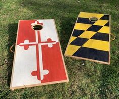 two cornhole boards sitting in the grass