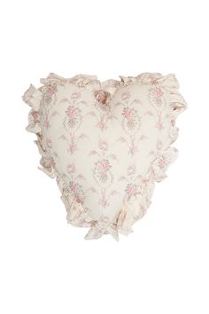 a heart shaped pillow with ruffled edges and pink flowers on the front, against a white background