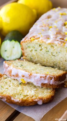 two slices of lemon zucchini bread sitting on top of a cutting board