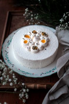 a white cake on a plate with flowers