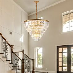 a chandelier hanging from the ceiling in a foyer