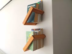 two bookshelves are mounted to the wall