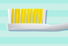 a yellow toothbrush sitting on top of a blue and white striped wall next to it's holder