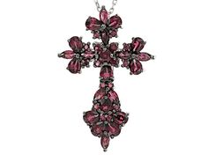 .42ctw round, .90ctw marquise and 2.40ctw pear shape raspberry color rhodolite garnet rhodium over sterling silver cross pendant with 18" Singapore chain. Measures approximately .31"L x .88"W. 2.5mm bail. Lobster claw clasp with a 2" extender. Finished back. Black rhodium. Silver Multi-stone Pear-shaped Jewelry, Silver Marquise Jewelry With Gemstone Accents, Silver Jewelry With Marquise Gemstone Accents, Silver Pear-shaped Multi-stone Jewelry, Silver Jewelry With Gemstone Accents In Marquise Shape, Pear-shaped Multi-stone Silver Jewelry, Silver Pear-shaped Gemstone Jewelry, Raspberry Color, Sterling Silver Cross Pendant