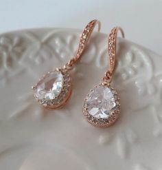 Crystal Rhinestone Bridal Earrings Rose Gold, Wedding Jewelry, Sparkling Cubic Zirconia Statement Earrings, Luxury CZ Bridal EarringsBeautiful  and elegant Dangle Sparkling Teardrop earrings inRose Gold finish are featuring gorgeous delicate Cubic Zirconia Sparkling Teardrops and hooksThese are so fabulous looking, really sparkle and shine!Perfect to your wedding day, bridesmaids and the Bride !• RoseGold framed Teardrops• Rose Gold plated ear hooks with faceted glass cubic stones RhinestonesTot