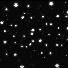 white stars are flying in the night sky