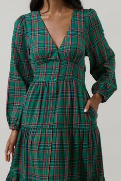 Enter fall season with great looks, including the Jace Plaid Shely Button Down Midi Dress. Long sleeves with elastic cuffs, frame a v neckline with a button-down placket all the way down to the midi length. This tiered dress will look extra cute with short boots or heels. - Plaid- Midi- Balloon long sleeves- Tiered- Color: Green MultiSize + Fit - Model is 5'9" and wearing size XS- Measurements taken from size S - Chest: 17"- Length: 49" Fabric Self: 100% Cotton, Lining: 97% Polyester 3% Spandex Casual Green Dresses With Button Cuffs, Casual Green Dress With Button Cuffs, Green Button-up Dress With Button Cuffs, Green V-neck Dress With Buttons, Green Daywear Dresses With Button Cuffs, Family Christmas Photos, Green Plaid Dress, Button Down Midi Dress, Thanksgiving Fashion