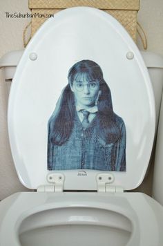 a toilet with the lid up and an image of a woman on it