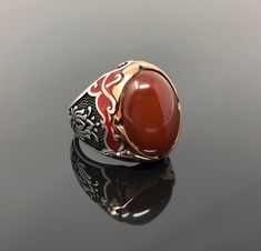 -Stone Type: Natural Red Agate (aka Aqeeq) -Stone Dimensions: 2.1 cm x 1.5 cm -Metal Type: Sterling Silver(925k) & Bronze Details (Yellow Part) -Weight of the Item: 17gr (Approx.) All items comes in a special gift box. If you don't see your size, please ask, we may produce your size. You are looking at the high quality handcrafted silver ring. All of our items have been designed and produced by ourselves ,so all our items comes with 1 year warranty as well. International shipping(customers f Red Oval Enamel Ring For Gift, Oval Red Enamel Ring For Gift, Red Inlay Rings For Gifts, Red Gemstone Enamel Ring Gift, Red Enamel Gemstone Ring For Gift, Red Enamel Ring With Gemstone Gift, Red Carnelian Signet Ring For Anniversary, Red Cabochon Signet Ring Gift, Collectible Red Carnelian Ring