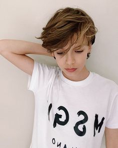 a young boy wearing a white tshirt with the msg logo on it