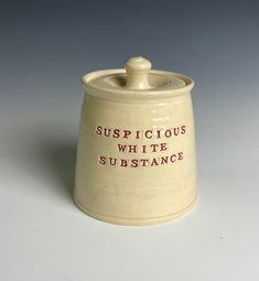 a ceramic container with the words suspicious white substance on it