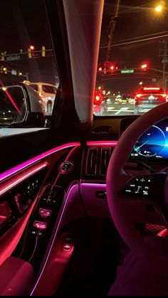 the interior of a car with red and blue lights on it's dash board